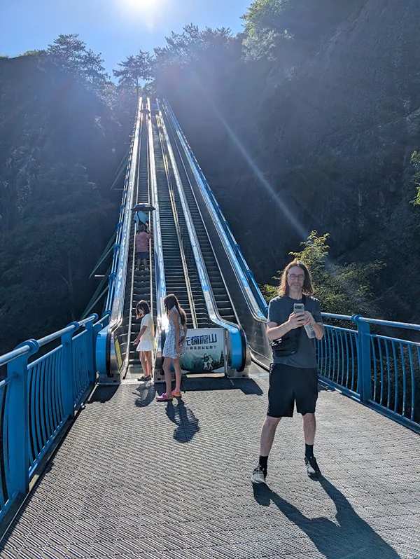 Outdoor escalators running up the mountainside