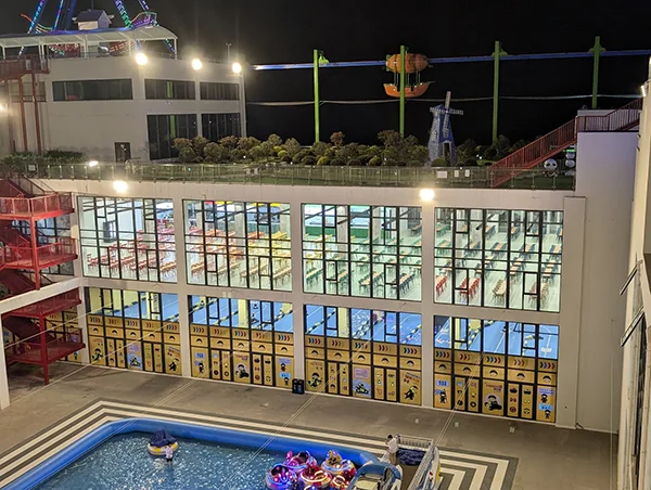 The lit-up rooftop rides and empty dining halls at night