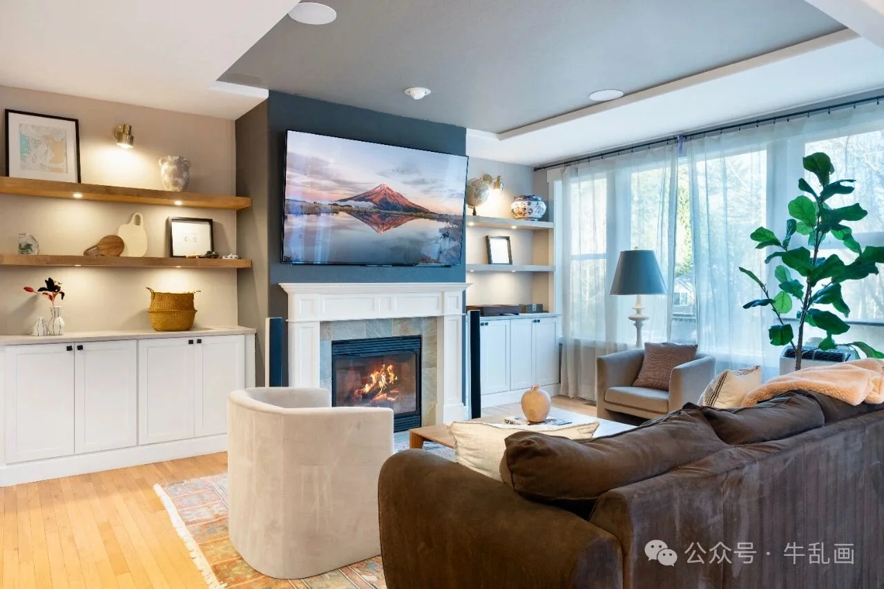 Staged living room with fireplace and large windows