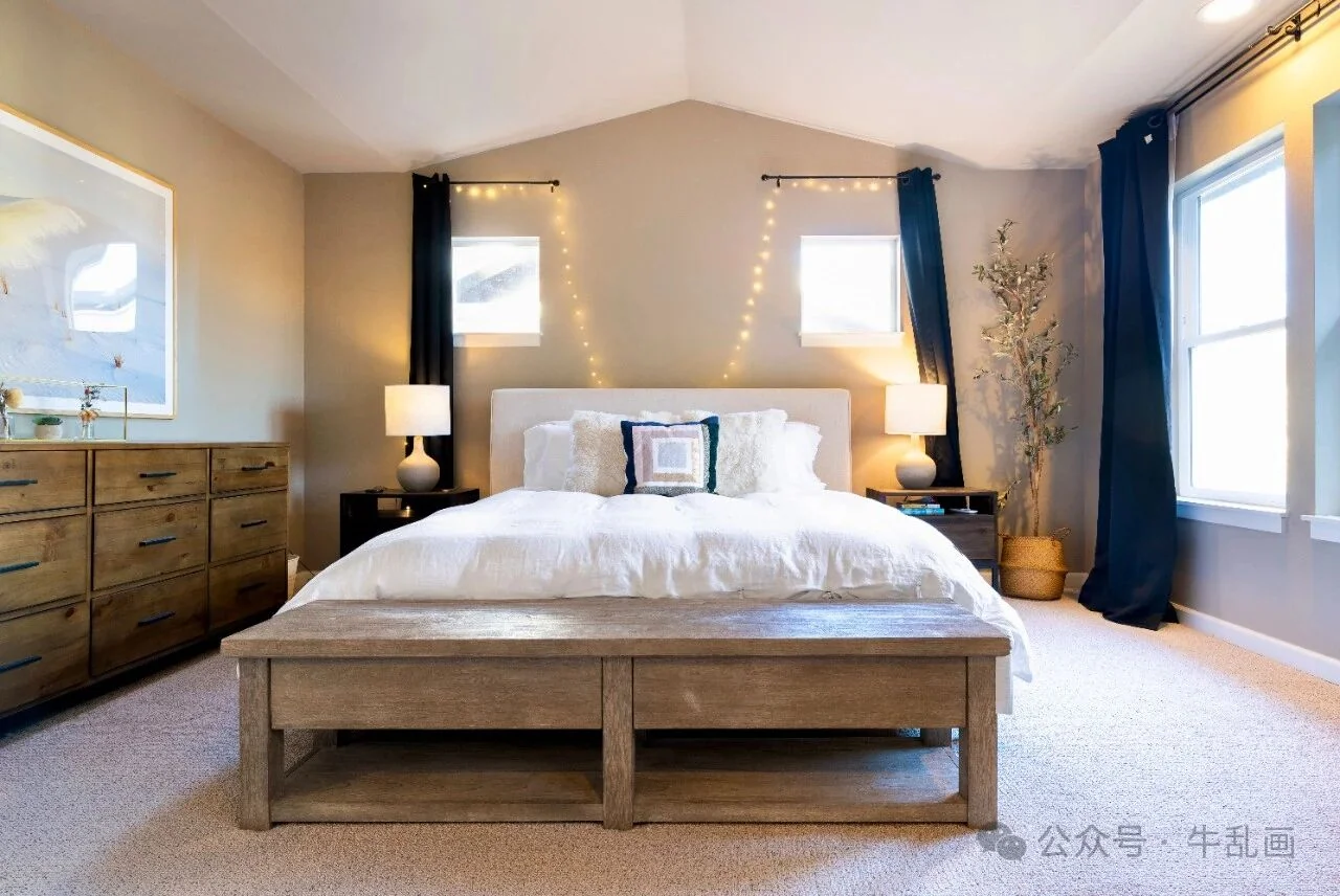 Staged main bedroom with string lights and a wooden bench