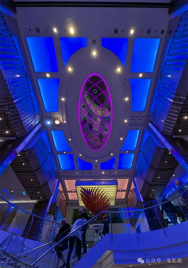 Blue-lit atrium ceiling and staircase