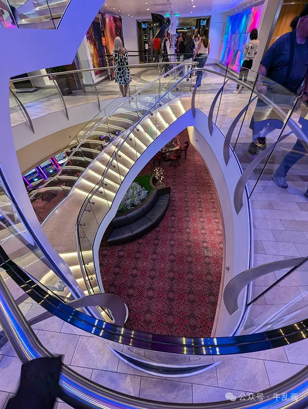 Curved staircase looking down into a lounge