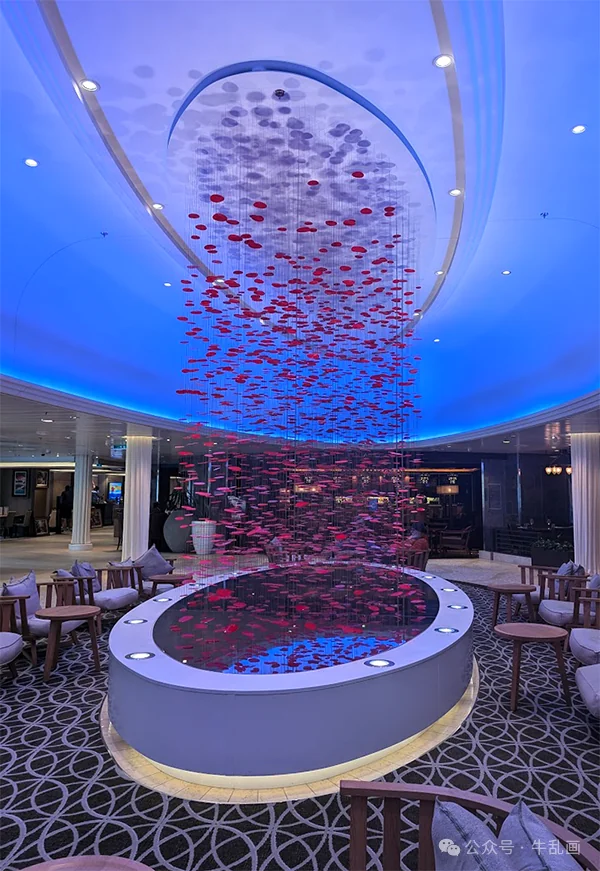 Chandelier of red glass discs above a bar