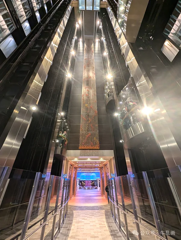 Soaring elevator atrium with a beaded light sculpture