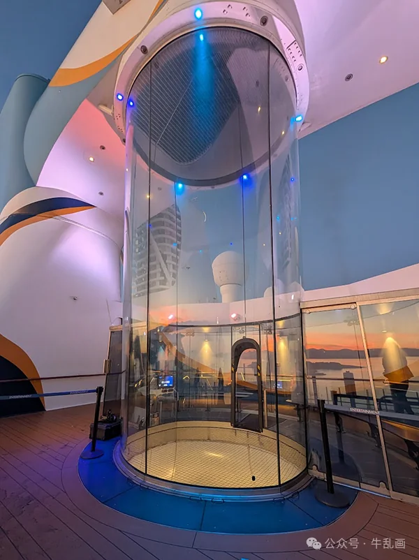 The glass skydiving simulator tube at sunset
