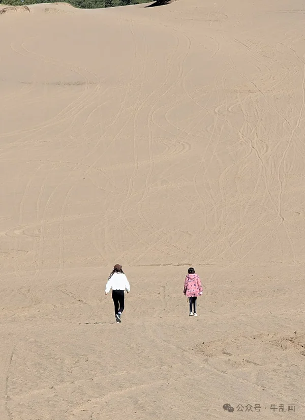 The girls walking up a sand dune — a desert in the middle of the forest